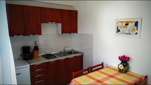 a kitchen with a table and a sink and a table and chairs at Apartments Kalac in Labin