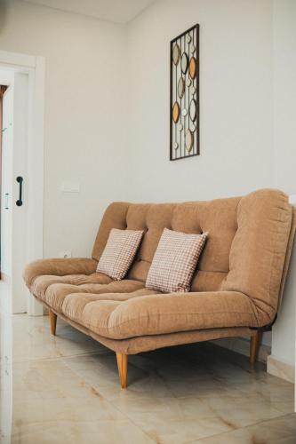 a brown couch in a living room with two pillows at Jasmin 2 in Alanya