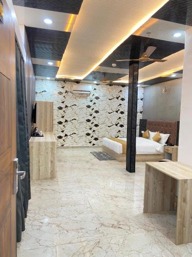 a room with a bed and a wall of wine bottles at Hotel Ganga Pearl in Rishīkesh
