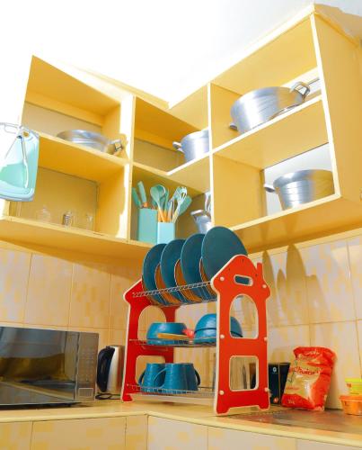 a kitchen counter with a microwave and some dishes at Shizzle cozy homes in Kisii