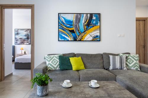 a living room with a couch and a painting on the wall at Invictus 2-Bedroom Apartment in Larnaca