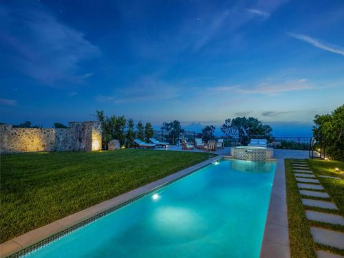 a swimming pool in the middle of a yard at night at Casa Tranquila Malibu in Malibu