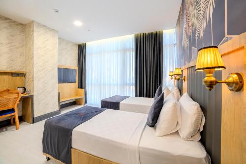 a hotel room with two beds and a desk at Bulton Hotel Airport in Arnavutköy