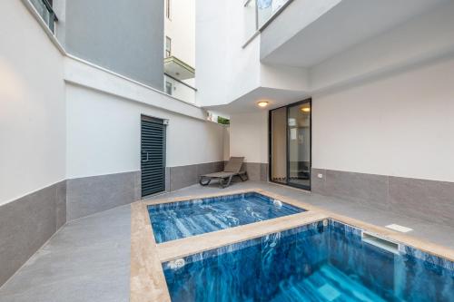 a swimming pool in the middle of a house at Jasmin 2 in Alanya