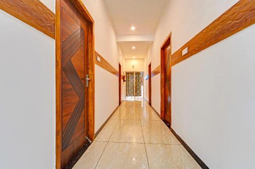 an empty corridor with a door and a hallway at FabHotel Raja Residency in Alāndurai