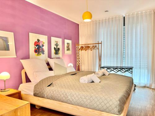a bedroom with a bed with a stuffed animal on it at Snug Stays 7 - Design House in Starnberg, Terrace, Lake, Munich south in Starnberg