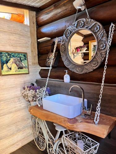 a bathroom with a sink and a mirror at Lavender House in Slavske