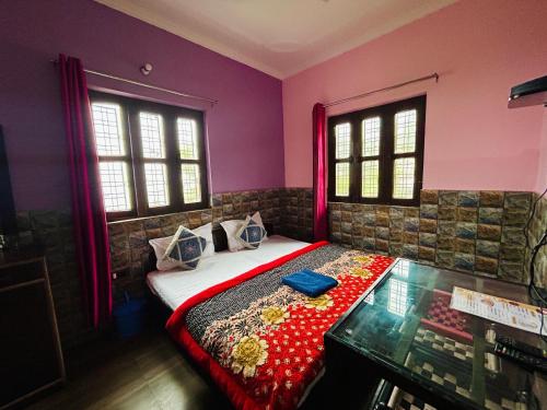 a bedroom with a bed and two windows at Green Valley Hotel in Lansdowne