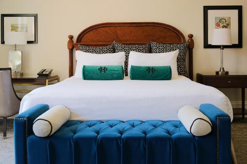 a bedroom with a large bed with a blue ottoman at The Oxford Hotel in Denver