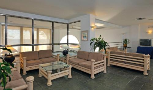 a living room with couches and a table at Sol Los Fenicios in La Herradura