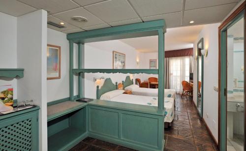 a bedroom with a bed and a large mirror at Sol Los Fenicios in La Herradura