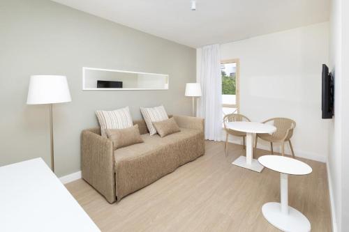 a living room with a couch and a table at Sol Fuerteventura Jandia - All Suites in Morro del Jable