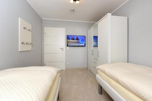 Postel nebo postele na pokoji v ubytování Meckis Panorama-Suiten in der Residenz Waterkant