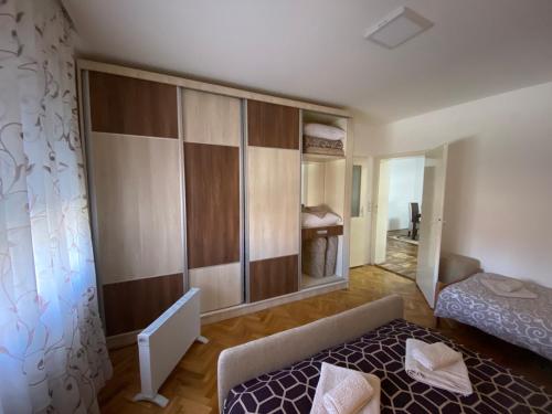 a small room with a bed and a mirror at Apartmani Milojić in Soko Banja