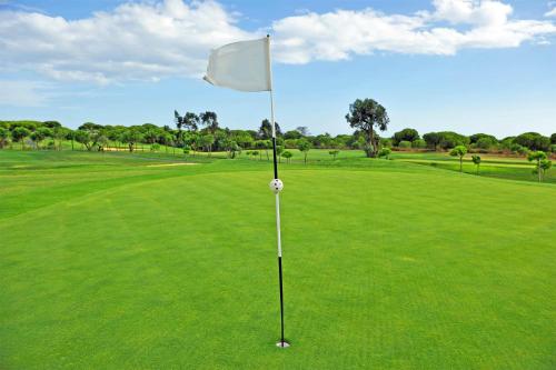 a white flag on a putting green at Barceló Isla Canela in Isla Canela