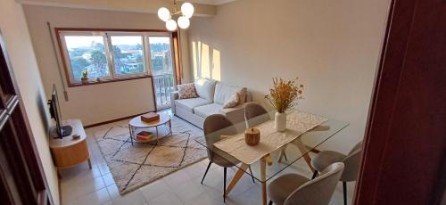 a living room with a couch and a table at Placido's in Aveiro