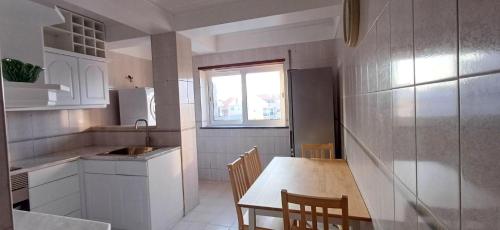 a kitchen with a table and chairs in a room at Placido's in Aveiro