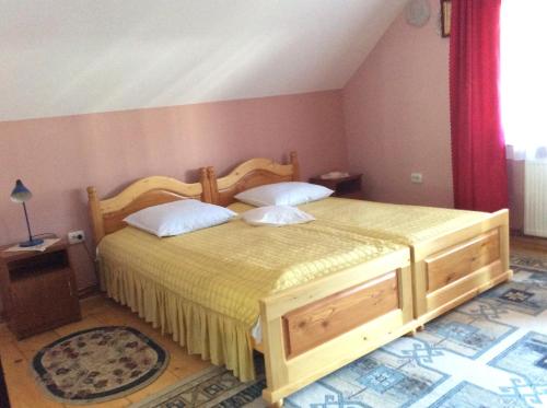 a bedroom with two beds in a room at Casa Andrada & Ilinca in Gura Humorului
