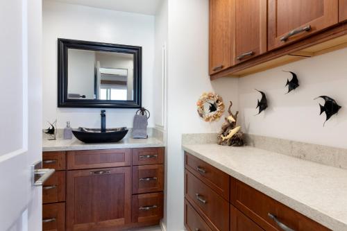 a bathroom with a sink and a mirror at Incredible Ocean Views in Kailua-Kona