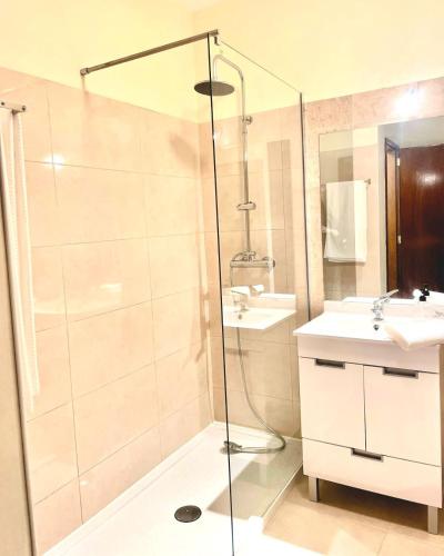 a bathroom with a shower and a sink at Varandas do Pinhal in Fão