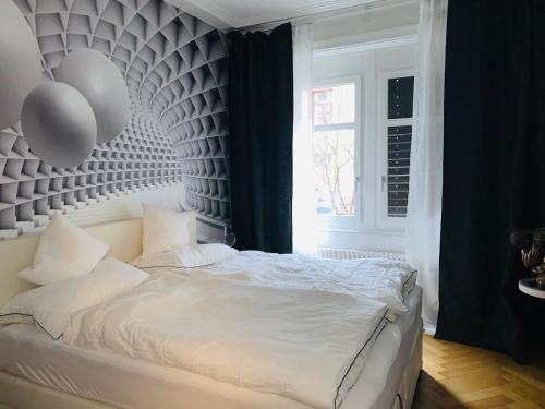 a bedroom with a white bed with balloons on the wall at City AppartementStJakob10minSBB5minMesse10min in Basel