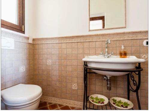 a bathroom with a sink and a toilet at VitaLenta in Naxos in Giardini Naxos