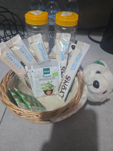 a basket filled with toothbrushes and a teddy bear at Cozy Retreat in Kelly Village