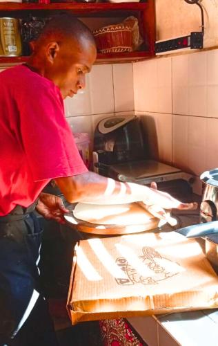 a man is preparing food on a cutting board at Fleurs d'Ylang in Nosy Be