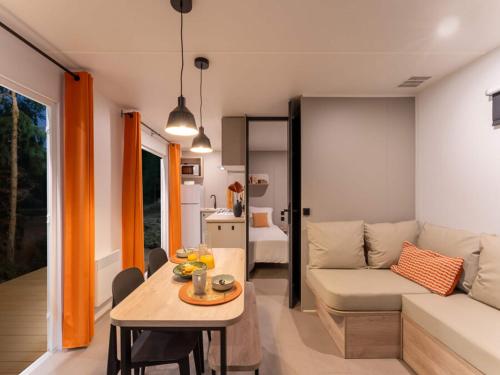 a living room with a couch and a table at Camping L'Etang D'Ardy *** in Saint-Paul-lès-Dax