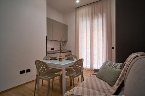 a living room with a table and chairs and a couch at Gelone - Cairoli Apartments in Gela