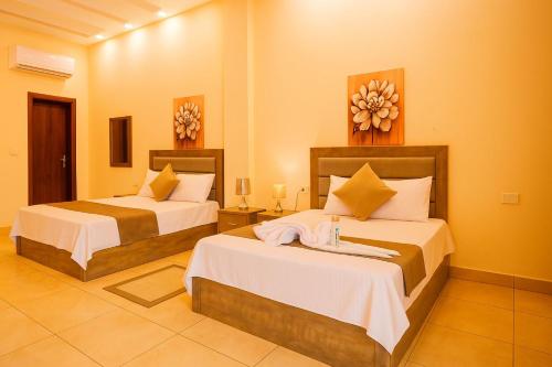 a hotel room with two beds in a room at الف ليله و ليله اكوا بارك بورسعيد in Port Said