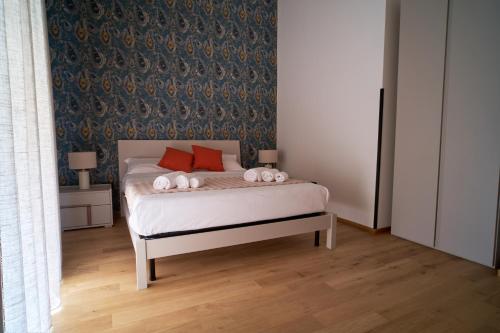 a bedroom with a bed with two stuffed animals on it at Gelone - Cairoli Apartments in Gela