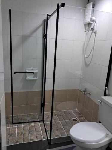 a bathroom with a shower and a toilet at Patong Tower by United 21 Thailand in Patong Beach
