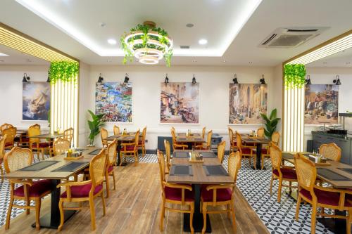 a restaurant with wooden tables and chairs at Bulton Hotel Airport in Arnavutköy
