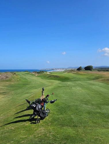 a golf cart is parked on a golf course at Varandas do Pinhal in Fão