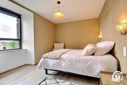 a bedroom with a bed and a window at Gite de branfere in La Gacilly