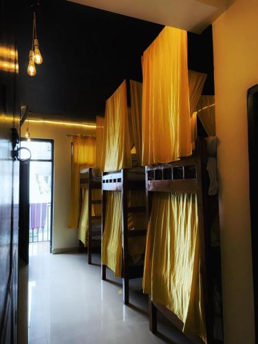 a room with a kitchen with curtains on the wall at Friends by Alizeh Bhagsunag McLeodganj in McLeod Ganj