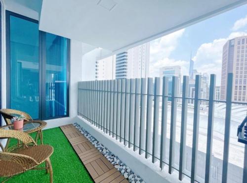 a balcony with chairs and a view of the city at Luxe by KLCC in Gua Sai