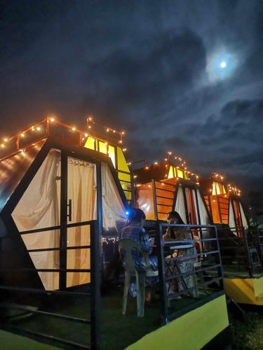 a group of tents in a field at night at Dewpod in Polomolok