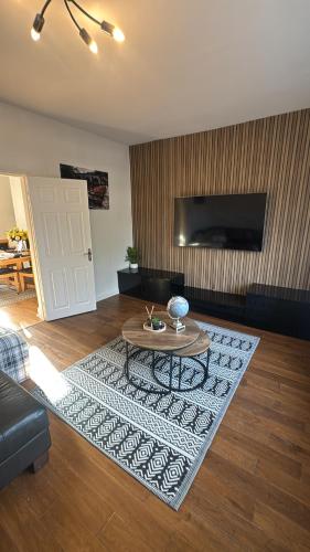 a living room with a table on a rug at The Coach House - 1 mile from Beamish Museum in Beamish