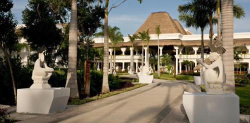a resort with statues in front of a building at Grand Sunset Princess - All Inclusive in Playa del Carmen