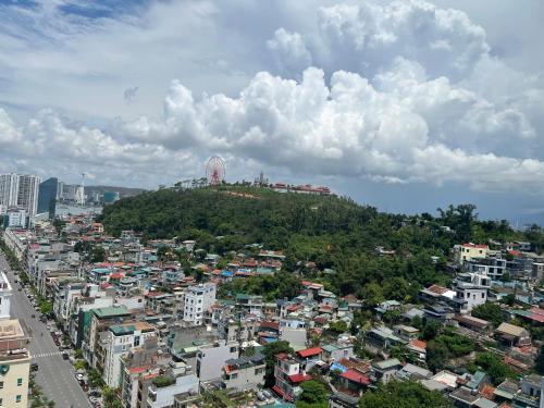 an overhead view of a city with buildings and a hill at Căn Hộ Hướng Biển Xem pháo hoa gần Vincom,Bảo Tàng Quảng Ninh in Ha Long