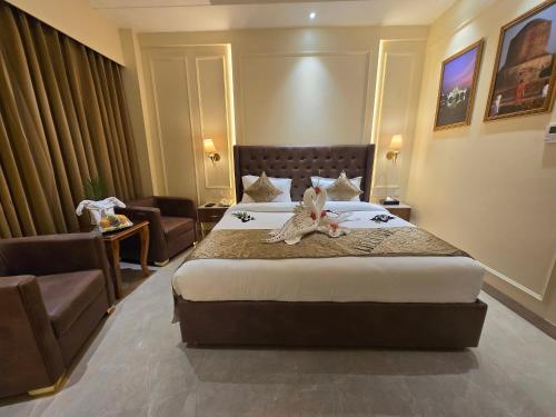 a hotel room with a bed with two stuffed animals on it at Hotel Regal Club and Resort in Malhour