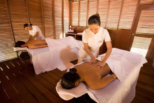 a woman giving a man a massage on a bed at Grand Riviera Princess - All Inclusive in Playa del Carmen