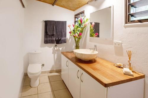 a bathroom with a bowl sink and a toilet at Angels Beachhouse - Beachfront, fast internet, Queen beds, new owners in Port Vila