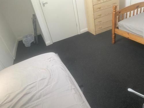 a bedroom with a bed and a dresser at The Haven Loft-Cozy Room in a house in Grays Thurrock