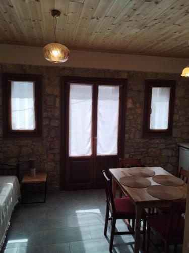 a dining room with a table and some windows at Jenny's House II in Skiathos Town