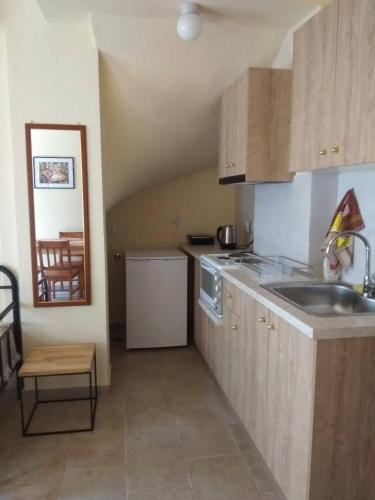 a kitchen with a sink and a counter top at Jenny's House in Skiathos