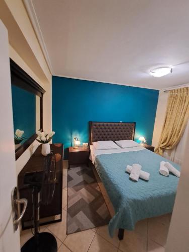 a bedroom with a bed with two towels on it at Apartment Margarita in Athens