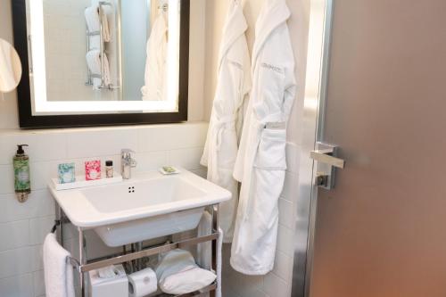 a bathroom with a sink and a mirror at Starhotels Michelangelo Florence in Florence